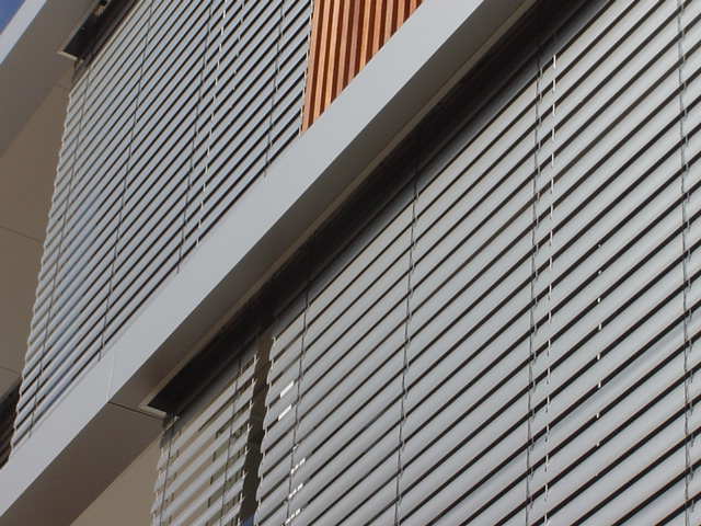 Venetian blinds across a run of resort windows